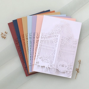 Detailed laser-cut wedding invitation covers featuring elegant carriage and gate patterns