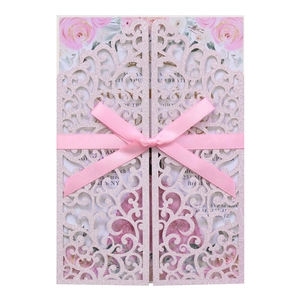 Détail d'invitation rose pailletée découpée au laser avec roses et nœud en satin