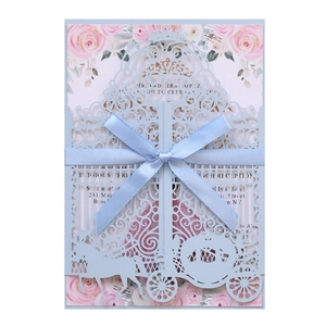 Detailed laser-cut pumpkin carriage wedding invitation with blue silk bow and floral liner