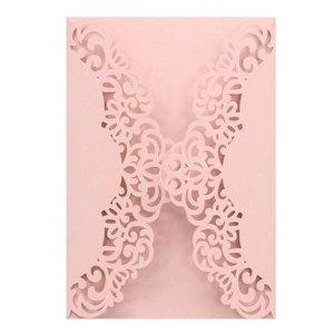 Detail of pink laser-cut floral invitation envelope with intricate symmetrical patterns