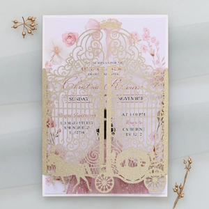 Detailed laser cut gold glitter invitation featuring hollow crown and pumpkin carriage design