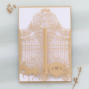 Detail of laser-cut crown and carriage wedding invitation in champagne gold pearl paper