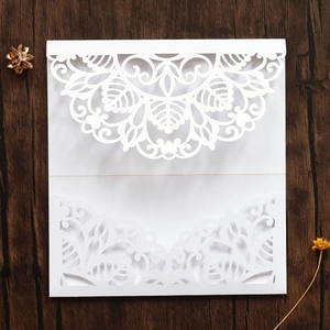 Detailed laser-cut white wedding invitation pocket with elegant mandala lace pattern