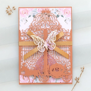Detailed laser-cut wedding invitation featuring elegant hollow patterns and a 3D butterfly