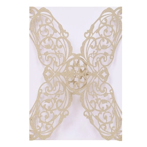 Detail of laser-cut butterfly invitation cover with gold glitter finish and floral patterns