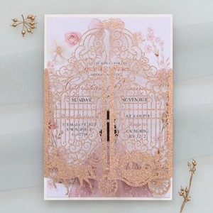 Detail of rose gold laser-cut wedding invitation featuring a carriage and floral insert
