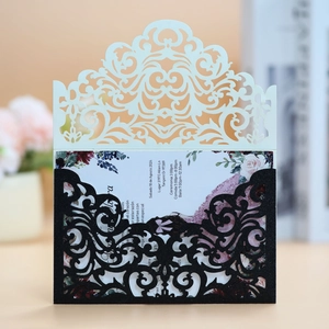 Detail of glitter laser-cut wedding invitation with elegant floral card insert