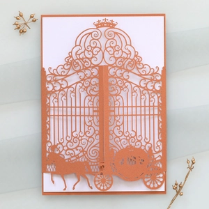 Intricate laser-cut wedding invitation featuring rose gold glitter paper and horse carriage