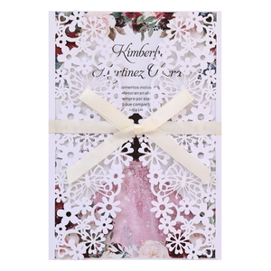 Detail of laser-cut butterfly wedding invitation with white ribbon and floral insert