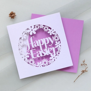 Detail of laser-cut Happy Easter card with white daisy patterns and purple envelope