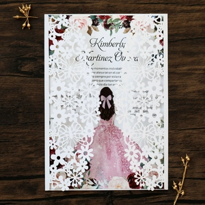 Detail of laser-cut butterfly hollow pattern and elegant invitation card on wood