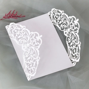 Detail of laser-cut invitation card with floral patterns on a mesh fabric background