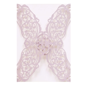 Macro shot of laser-cut butterfly invitation cover with purple glitter finish and floral details