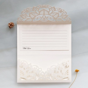 Detailed laser-cut wedding invitation in cream with With Love insert and floral envelope