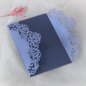Detail view of laser-cut lace pattern on elegant blue wedding invitation card
