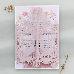 Macro view of laser-cut pink glitter wedding invitation with pumpkin carriage design