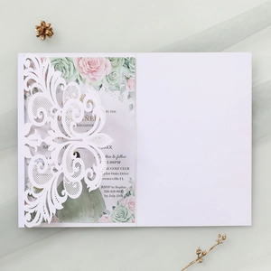 Intricate laser-cut lace wedding invitation with delicate floral printed insert on silk