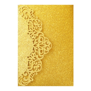 Detailed laser-cut scroll patterns on gold glitter paper wedding invitation card