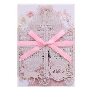 Detailed laser-cut glitter pink pumpkin carriage invitation with a satin ribbon bow