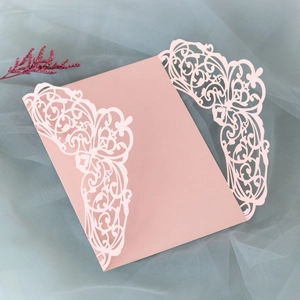 Detailed laser-cut floral pattern on light pink wedding invitation card pocket