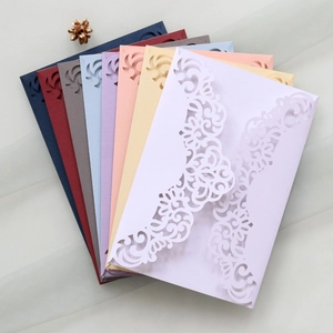 Detailed laser-cut vine patterns on multi-color lace invitation covers with textured paper