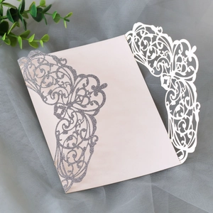 Macro detail of laser-cut wedding invitation cover with silver glitter floral patterns