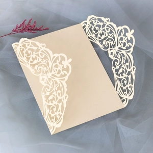 Close-up of laser-cut hollow pattern on elegant off-white specialty paper card