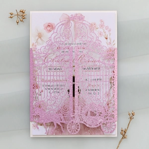 Detail of laser-cut glitter wedding invitation with elegant pink hollow gate design