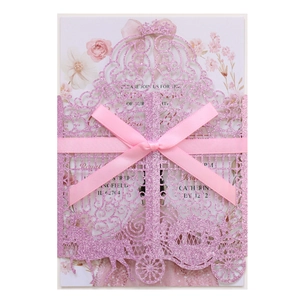 Pink glitter laser-cut invitation featuring a pumpkin carriage design and silk bow