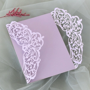 Detailed laser-cut purple wedding invitation cover with elegant floral lace pattern
