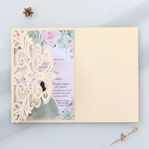 Macro detail of laser-cut lace floral pattern on elegant wedding invitation cover