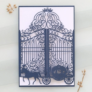 Detail of navy blue laser-cut wedding invitation with crown and carriage design