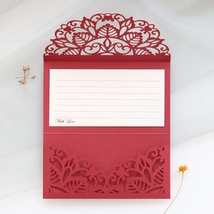 Detail of red laser-cut floral invitation cover with With Love printed inner card