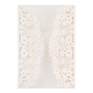 Macro view of laser-cut white wedding invitation featuring intricate butterfly and floral patterns