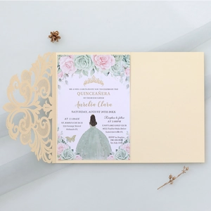 Close-up of laser-cut lace invitation featuring floral patterns and gold crown detailing
