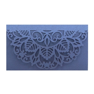 Laser-cut navy blue pearlescent paper wedding invitation with intricate mandala floral pattern