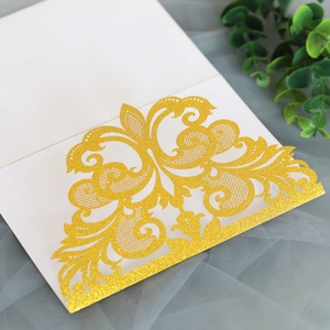 Detailed laser-cut scroll patterns on gold glitter lace wedding invitation cover