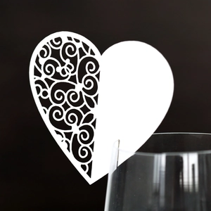 Detailed laser-cut heart paper place card with elegant vine patterns for wine glasses