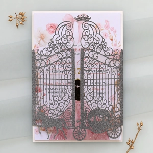 Intricate laser-cut castle gate and carriage detail on silver glitter invitation sleeve