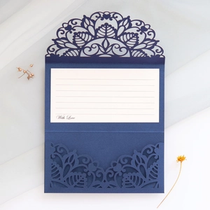 Close-up of laser-cut lace wedding invitation with white insert and With Love text