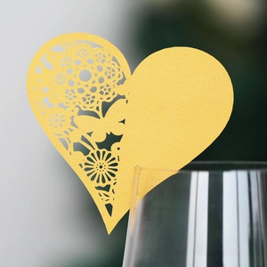 Elegant gold hollow heart place cards with butterfly and floral laser-cut patterns