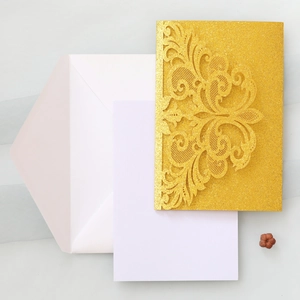 Detailed laser-cut gold glitter invitation cover with elegant European lace patterns