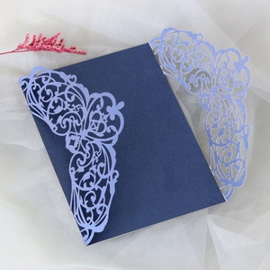 Detailed laser-cut lace pattern on navy blue invitation cover for weddings