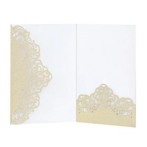 Macro view of golden glitter laser-cut invitation holder with intricate filigree details
