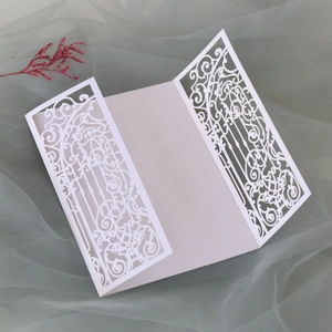 Elegant white laser-cut gatefold wedding invitation cover with intricate floral carving