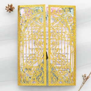 Detail of laser-cut gold glitter wedding invitation with elegant floral insert card