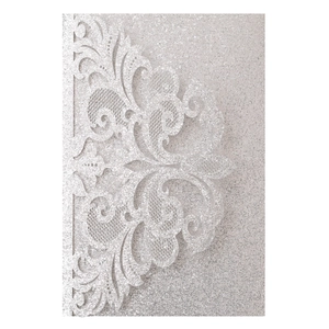 Detailed laser-cut damask patterns on silver glitter paper for wedding invitations