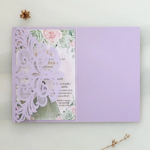 Detailed laser-cut purple invitation sleeve with floral inner card on white background