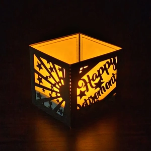 Detail of Happy Retirement laser-cut paper lantern shade with warm LED glowing effect