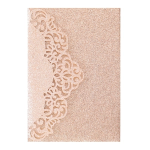 Detail of rose gold laser cut glitter invitation card with intricate hollow pattern